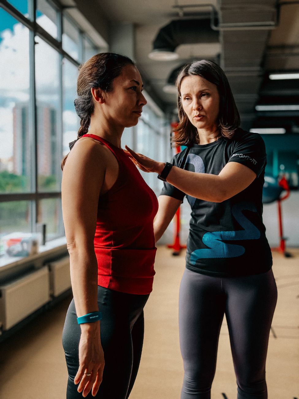 Trainer checking athlete's alignment